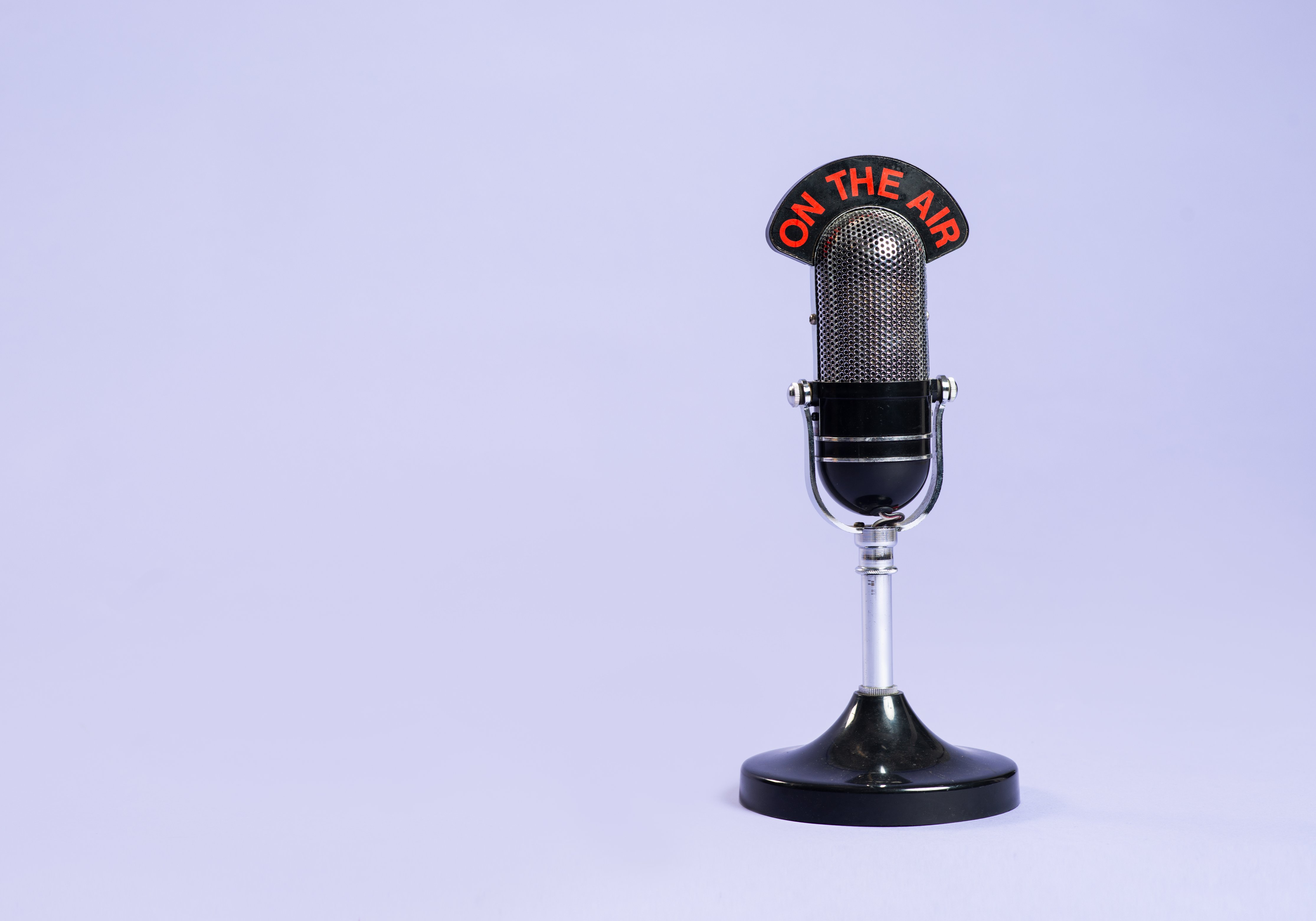 Retro radio microphone against a purple background